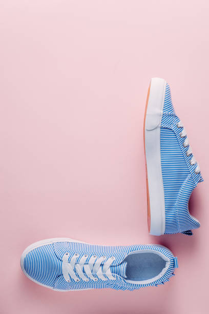 istock blue striped sneakers on pink pastel background 1049472824