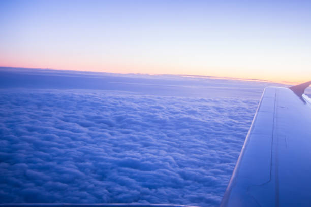 istock Wing of an airplane in the sunset 1049473270