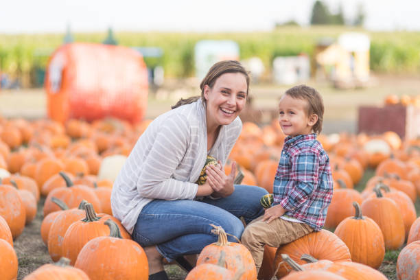 istock Mom and her little boy at the pumpkin patch 1049475432