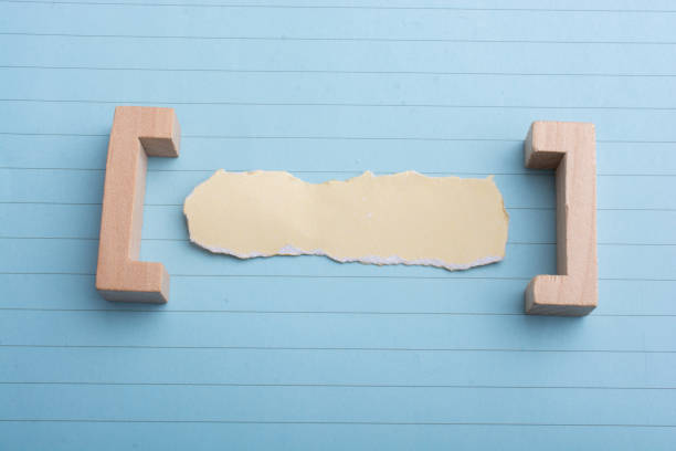 istock Little torn paper  on a sheet of paper 1049477340