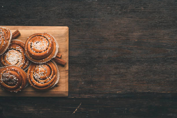 istock Traditional Swedish cinnamon bun on a wooden table 1049489430