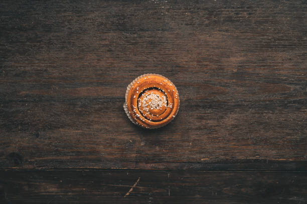 istock Traditional Swedish cinnamon bun on a wooden table 1049489726