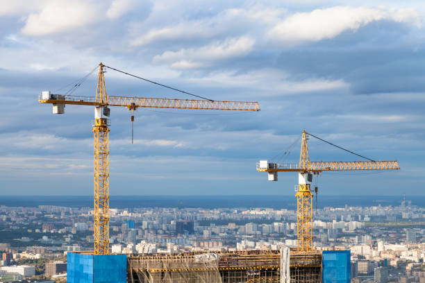 istock cranes at top of skyscraper under construction 1049489924