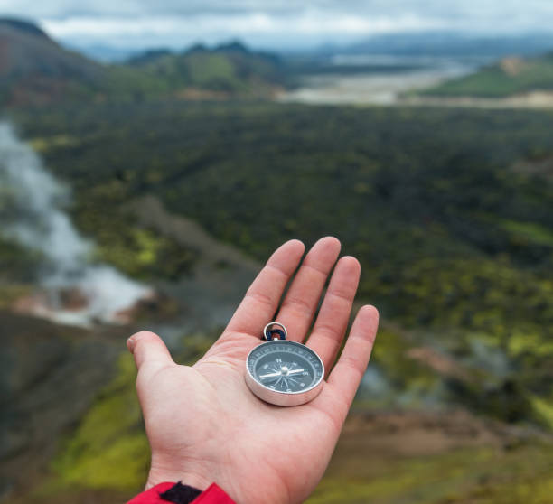istock Traveler holding compass in Iceland mountains 1049492678