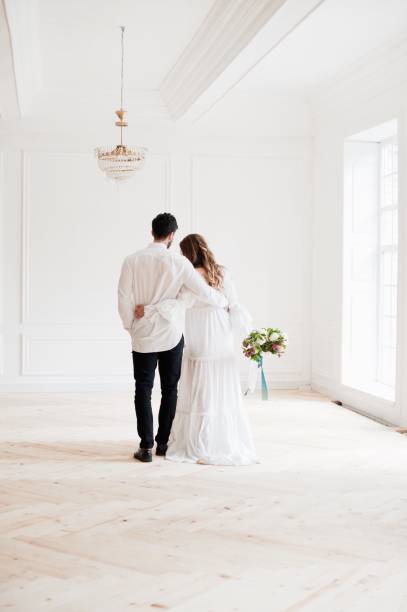 istock Young Couple Standing At Home 1049494448