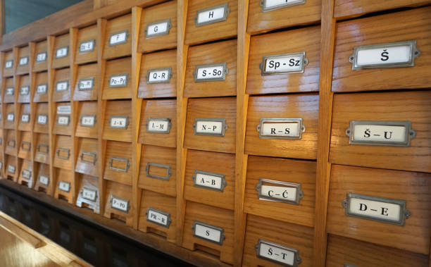 istock Library old wooden catalog with letters on drawers, side view 1049494690