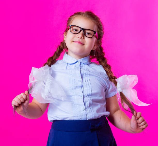 istock schoolgirl isolated against pink background 1049497290
