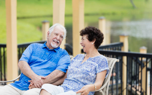 istock Senior Hispanic couple sitting outdoors, holding hands 1049498824