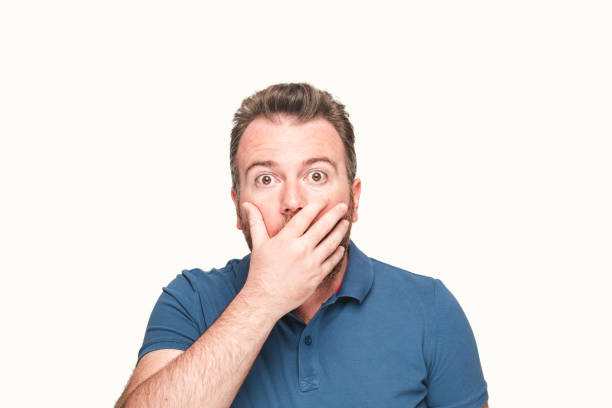 istock Mid adult man looking at camera with a shock expression 1049505336