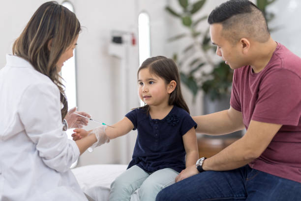 istock Young ethnic girl at the doctor's office getting a shot 1049505706