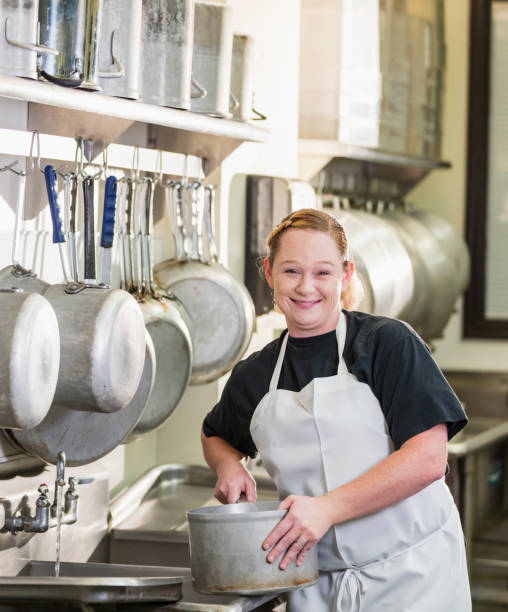istock Woman working in commercial kitchen 1049508894