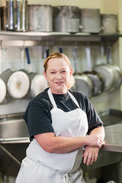 istock Woman working in commercial kitchen 1049509030