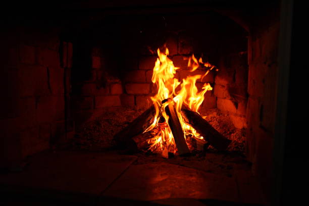 istock burning firewood in a brick fireplace 1049509532