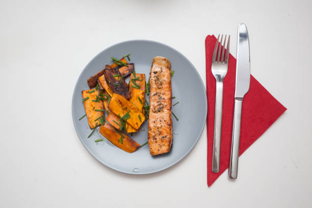 Home Cooked Dish: grilled salmon with sweet potato stock photo