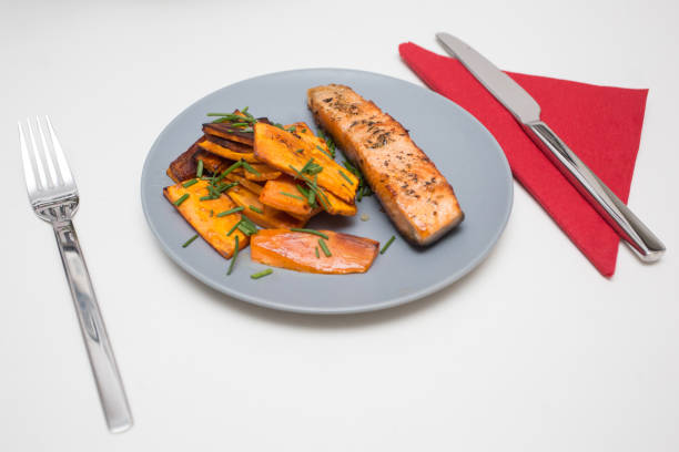 Home Cooked Dish: grilled salmon with sweet potato stock photo