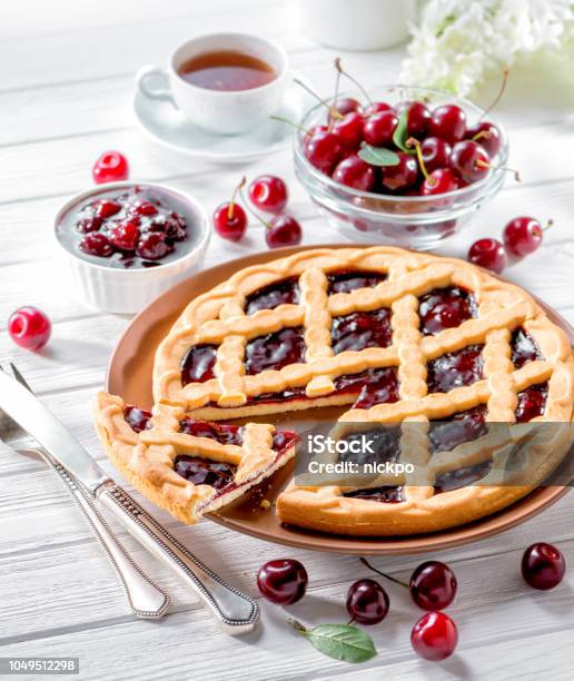 Cherry Tart On White Wooden Background Served With Fresh Berries Stock Photo - Download Image Now