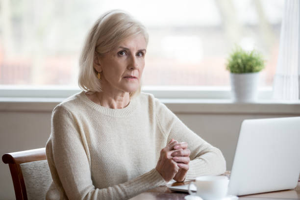 istock Thoughtful serious mature woman thinking of problem solution near laptop 1049512670
