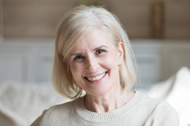 istock Happy middle aged elderly grey haired woman looking at camera 1049512828