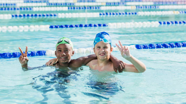 istock Multi-ethnic boys, best friends in swimming pool 1049513472