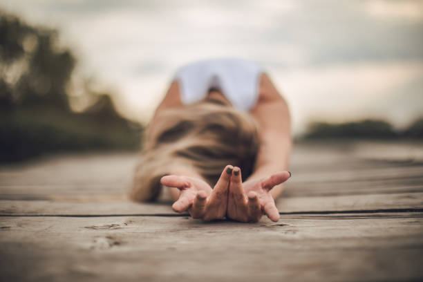 One woman, doing yoga outdoors alone.