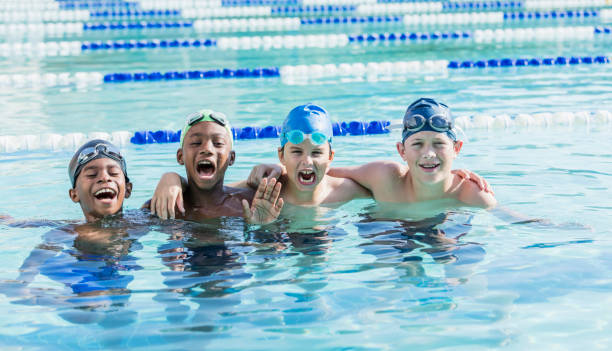 istock Multi-ethnic boys on swim team, shouting at camera 1049513704