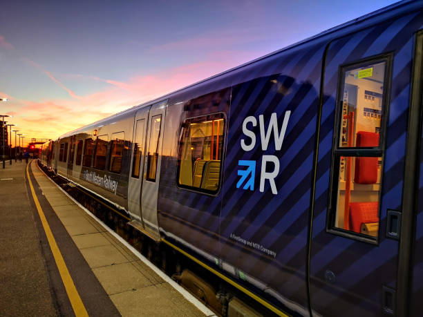 South Western Railway train at Basingstoke Basingstoke, UK. 24th September 2018.  A newly liveried South Western Railway Class 450 Desiro train is in the platform at Basingstoke Station just before sundown. hampshire england photos stock pictures, royalty-free photos & images