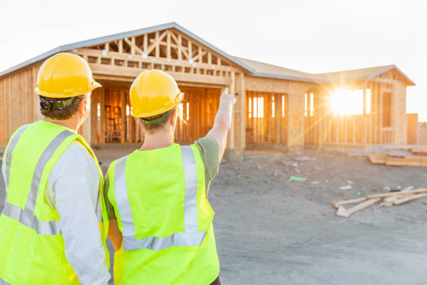 istock Male and Female Construction Workers at New Home Site 1049519900