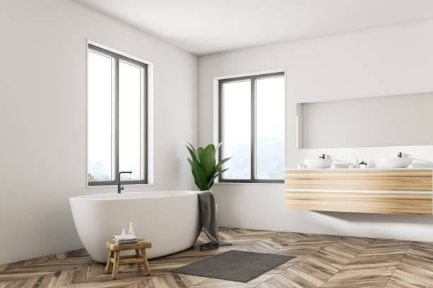 istock White Scandinavian bathroom corner, tub and sink 1049519960