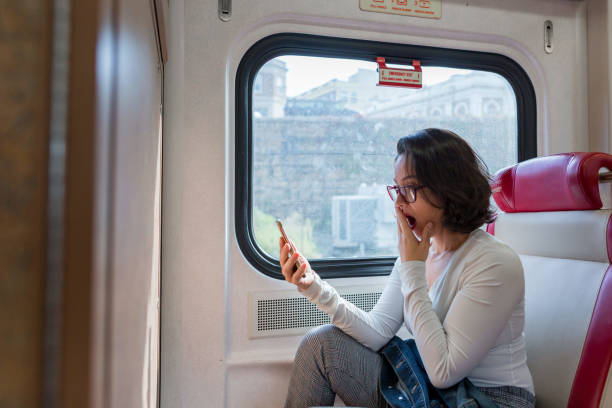 istock Surprise woman talking on the cellphone inside the train 1049524100