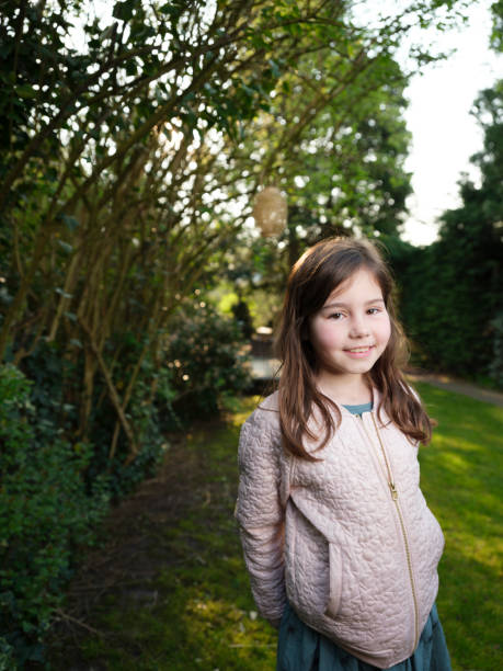 istock girl poses in garden 1049529900