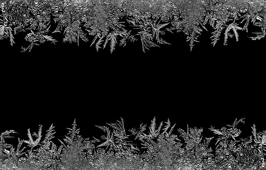 Natural ice crystals frostwork pattern on dark backround. Macro closeup.
