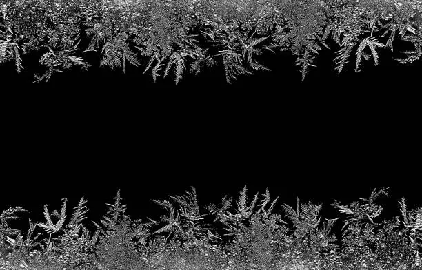 Natural ice crystals frostwork pattern on dark backround. Macro closeup.