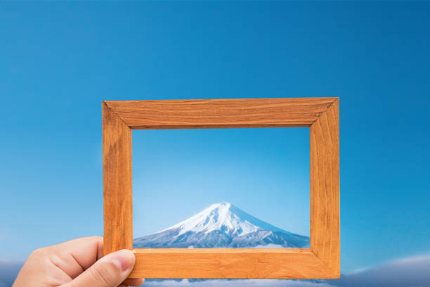 hand hold wood frame and focus Fuji mountain on background. image look like photo on the frame. nature wallpaper and background. hand hold wood frame and focus Fuji mountain on background. image look like photo on the frame. nature wallpaper and background. 3610 stock pictures, royalty-free photos & images