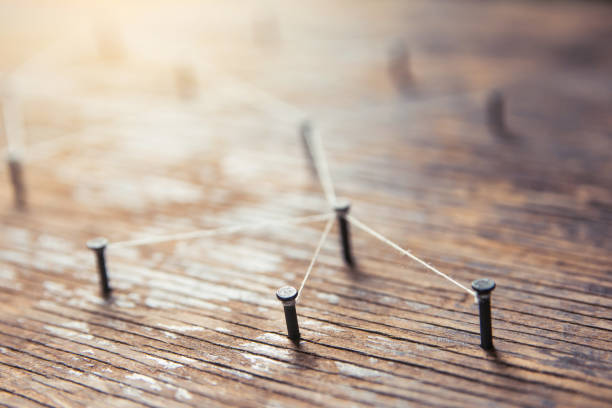 istock Connecting networks concept - network connected with yarn white on Plank wood with copy space. Simulator connection social media, internet, people communication, Linking entities 1049543296
