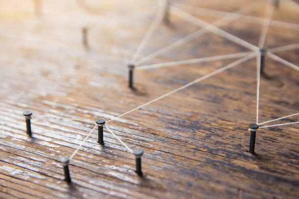 istock Connecting networks concept - network connected with yarn white on Plank wood with copy space. Simulator connection social media, internet, people communication, Linking entities 1049544846
