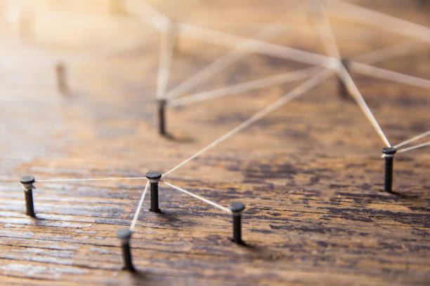 istock Connecting networks concept - network connected with yarn white on Plank wood with copy space. Simulator connection social media, internet, people communication, Linking entities 1049545638