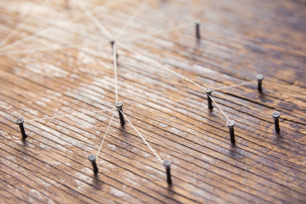 istock Connecting networks concept - network connected with yarn white on Plank wood with copy space. Simulator connection social media, internet, people communication, Linking entities 1049545762