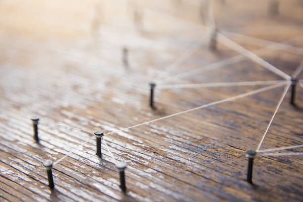 istock Connecting networks concept - network connected with yarn white on Plank wood with copy space. Simulator connection social media, internet, people communication, Linking entities 1049545868