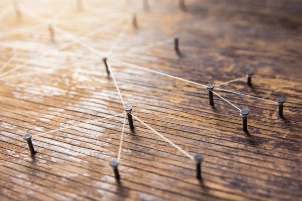 istock Connecting networks concept - network connected with yarn white on Plank wood with copy space. Simulator connection social media, internet, people communication, Linking entities 1049546018