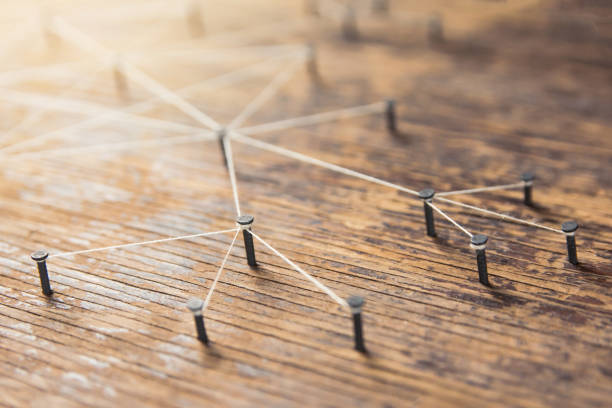 istock Connecting networks concept - network connected with yarn white on Plank wood with copy space. Simulator connection social media, internet, people communication, Linking entities 1049546082