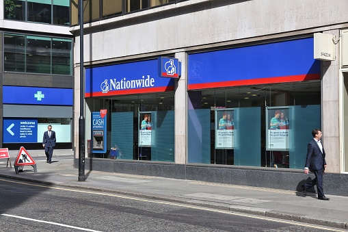 London: People walk by Nationwide Building Society in London. NBS is the largest building society in the world. It had 495.3 million GBP annual income in 2009.