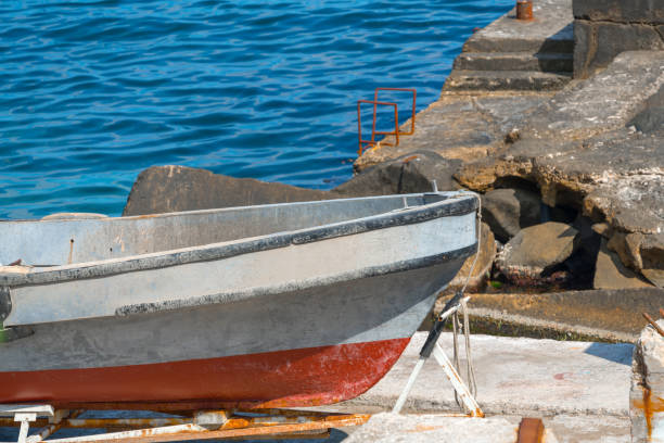 istock Small old boat on shore under repair 1049565462