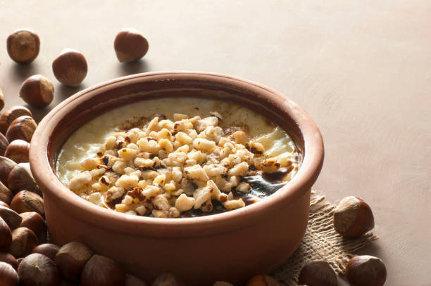 Baked rice pudding turkish milky dessert sutlac in earthenware casserole with hazelnuts