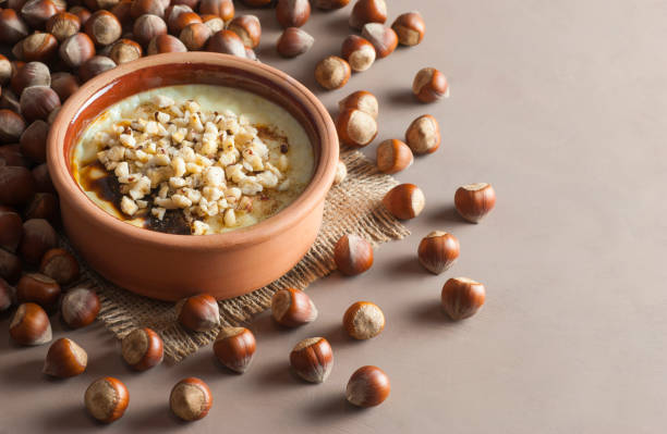 istock Baked rice pudding turkish milky dessert sutlac in earthenware casserole with hazelnuts 1049568270