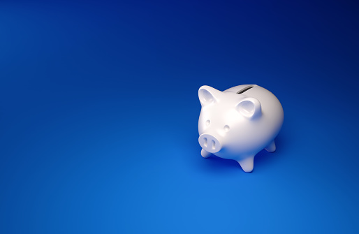 High angle perspective view of a small piggybank over blue background