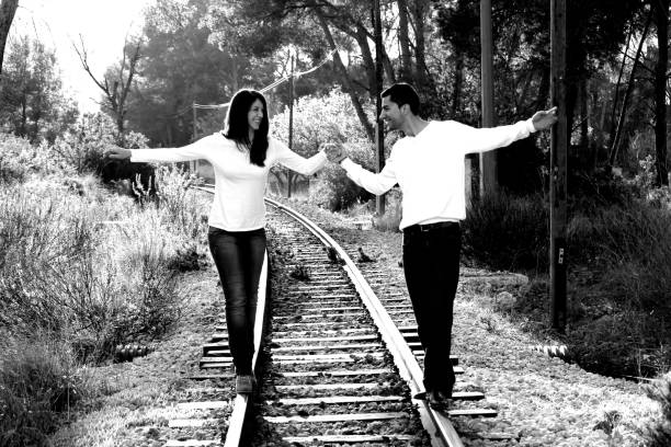 istock Young couple in love walking on a railroad 1049576690