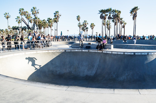 Venice Beach, Los Angeles, California - February 25 2018: Shadow of skater in halfpipe at Venice Beach skatepark at a sunny day