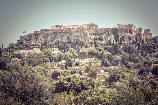 Acropolis hill, Athens, Greece. Scenic panorama of the ancient Greek Agora overlooking famous Acropolis. Landscape of the antique Athens center in summer. This place is the main landmark of Athens.