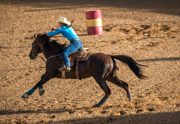istock Young cowgirl barrel racing rodeo 1049583912