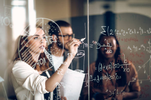 Writing Mathematical Formulas On Transparent Wipe Board Young Scientists Calculating Problems On Transparent Wipe Board transparent wipe board stock pictures, royalty-free photos & images